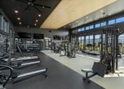 Thumbnail 17 of 94 - a gym with glass walls and a view of a golf course