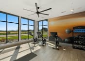 Thumbnail 22 of 94 - a home gym with windows and a view of a field