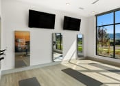 Thumbnail 23 of 94 - a yoga room with two monitors on the wall and yoga mats on the floor