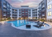 Thumbnail 20 of 25 - an empty swimming pool in an apartment building at dusk