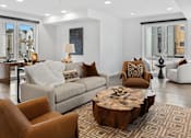 Thumbnail 10 of 45 - Bozeman, MT, Townhomes with attached Garage - Highmark Bozeman - Furnished Resident Lounge With Sofa Seating, Leather Accent Chairs, Large Windows, Modern Lighting, And Wood Coffee Table.