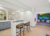 Thumbnail 5 of 36 - A kitchen with a white island and two chairs.