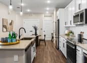 Thumbnail 69 of 94 - an open kitchen with a large counter top and a sink