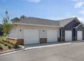 Thumbnail 44 of 49 - a house with two garages and a parking lot