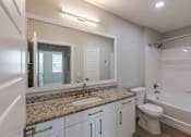 Thumbnail 25 of 37 - A bathroom with a sink, toilet, and bathtub.