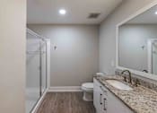 Thumbnail 26 of 37 - A bathroom with a sink, toilet, and mirror.
