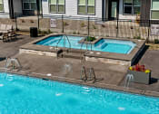 Thumbnail 57 of 94 - a swimming pool and spa in front of a house