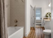 Thumbnail 16 of 46 - a bathroom with a bathtub and a toilet in a 555 waverly unit
