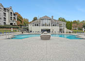 Thumbnail 34 of 36 - A large house with a pool in front.