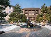 Thumbnail 9 of 28 - a fountain in the middle of a pool with a building in the background