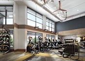 Thumbnail 8 of 28 - a gym with cardio machines and weights in a lobby