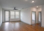 Thumbnail 38 of 40 - an empty living room with wood floors and a ceiling fan