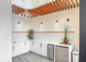 Thumbnail 6 of 40 - a laundry room with white cabinets and stainless steel washers and dryers