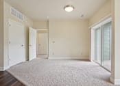 Thumbnail 23 of 42 - A room with a white carpet and a ceiling light.