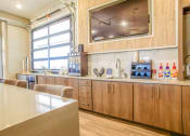 Thumbnail 39 of 60 - a kitchen with wooden cabinets and a counter top and a window