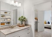 Thumbnail 14 of 46 - a bathroom with a sink and a mirror