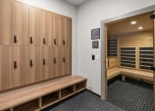 Thumbnail 25 of 94 - a locker room with wooden lockers and benches and a bench next to a door