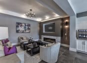 Thumbnail 4 of 25 - a living room with couches and chairs and a fireplace