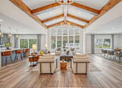 Thumbnail 1 of 36 - A spacious living room with wooden floors and a high ceiling.