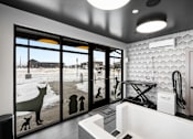 Thumbnail 37 of 94 - A bathroom with a large mirror and a dog silhouette on the window.