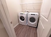 Thumbnail 32 of 71 - a small laundry room with a washer and dryer