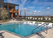 Thumbnail 17 of 40 - a swimming pool with lounge chairs at a hotel