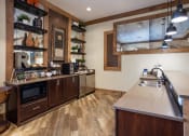 Thumbnail 16 of 30 - a large kitchen with stainless steel appliances and a sink