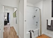 Thumbnail 32 of 49 - a bathroom with a shower and bathtub in a 555 waverly unit