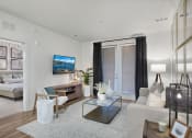 Thumbnail 25 of 49 - our apartments offer a living room with a couch a chair and a coffee table