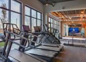 Thumbnail 12 of 40 - the gym at the monarch club has cardio equipment and large windows