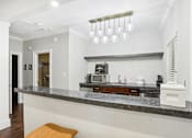 Thumbnail 18 of 28 - A kitchen with a marble countertop and a bench.