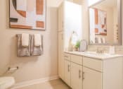 Thumbnail 52 of 60 - a bathroom with a sink and a mirror and a toilet