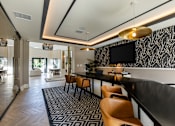 Thumbnail 9 of 53 - A modern dining area with a black and white patterned wallpaper.