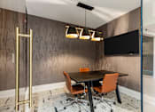Thumbnail 11 of 53 - A conference room with a brown wallpaper and a blackboard.