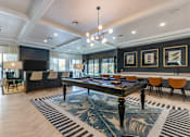 Thumbnail 13 of 53 - A large room with a pool table and chairs.
