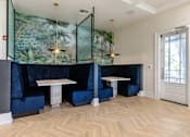 Thumbnail 12 of 53 - A room with a table and chairs with a green leafy wallpaper.