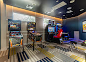 Thumbnail 18 of 53 - A room with a striped carpet and arcade games.