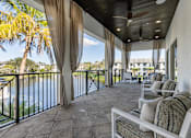 Thumbnail 45 of 53 - A balcony with a table and chairs overlooking a body of water.