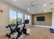 Thumbnail 17 of 53 - A room with exercise equipment and a flat screen TV.