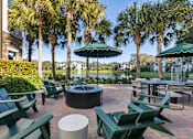 Thumbnail 48 of 53 - A patio with green chairs and tables.