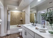 Thumbnail 31 of 53 - A modern bathroom with a white color scheme and a large mirror.