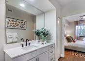 Thumbnail 29 of 53 - A bathroom with a white sink and a mirror above it.