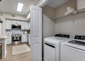 Thumbnail 33 of 53 - A laundry room with a washer and dryer.