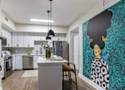 Thumbnail 23 of 53 - A woman with a large afro is painted on the wall of a kitchen.