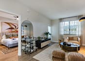 Thumbnail 25 of 53 - A bedroom with a large bed and a mirror on the wall.