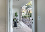 Thumbnail 34 of 53 - A view of a patio through an open door.