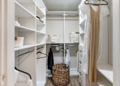 Thumbnail 32 of 53 - A white closet with a beige dress hanging on the rack.