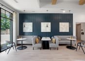 Thumbnail 20 of 46 - a seating area with couches and tables in front of a blue accent wall