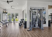 Thumbnail 14 of 49 - a home gym with exercise equipment and a large window