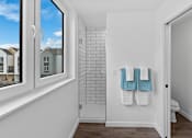Thumbnail 16 of 45 - A bathroom with a towel rack holding two towels.